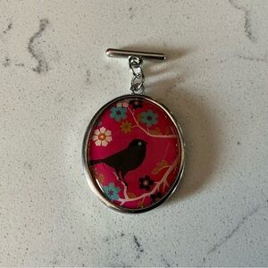 Silver multicolored pendant with bird silhouette